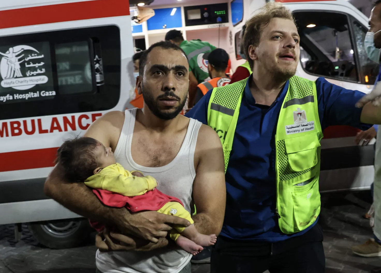 ▲加沙一男子抱着婴儿寻求治疗
