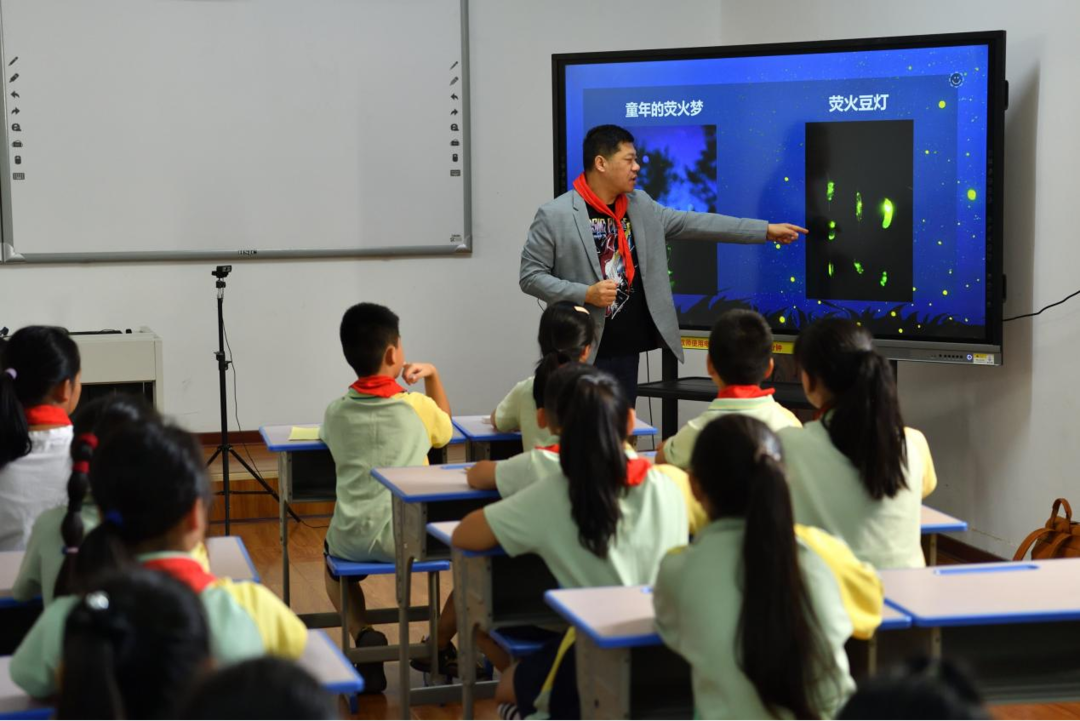 ▲华中农业大学植物科学技术学院教授付新华在给孩子们进行萤火虫科普。陈逸航 摄